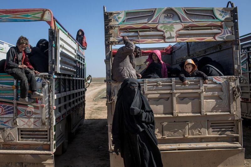 Civilians who have fled fighting in Bagouz wait to board trucks. Getty Images