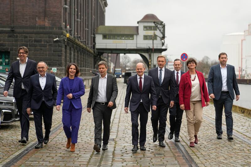 Social Democratic Party chancellor candidate Olaf Scholz, centre, arrives with the SDP's Norbert Walter-Borjans, second left, and Saskia Esken, second right; Green party leaders Annalena Baerbock, fourth left, and Robert Habeck, third left; the Free Democratic Party Chairman Christian Lindner, fourth right, and Volker Wissing, third right, for a joint news conference in Berlin on November 24. AP