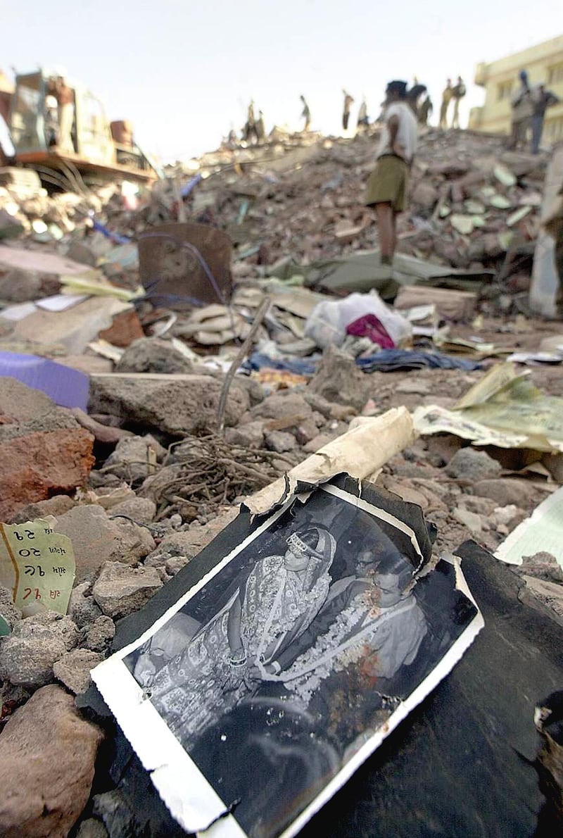 A wedding photo belonging to one of the residents of Bhuj lies in the rubble of a building, 30 January 2001, that collapsed in the massive 7.9 magnitude earthquake 26 January.  Rescue efforts continued following the massive temblor that has claimed thousands of lives in India's northwestern state of Gujarat.   AFP PHOTO/Arko DATTA (Photo by ARKO DATTA / AFP)