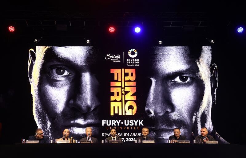 A general view of a screen advertising the fight behind the fighters, speakers and promoters. Getty 