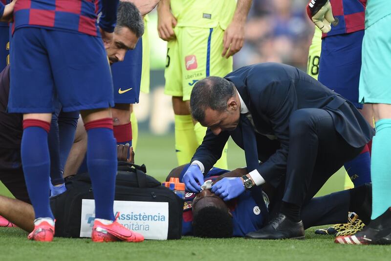 Barcelona's Samuel Umtiti receives medical attention. AFP