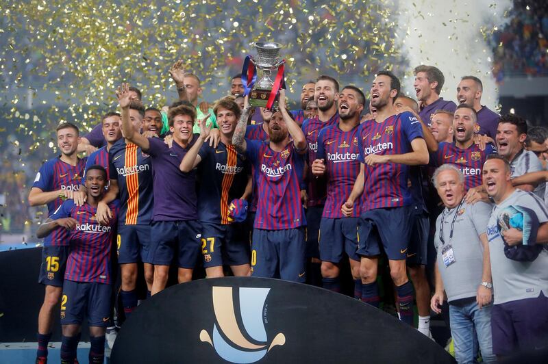 Barcelona's Lionel Messi, the new captain of the team, lifts the trophy. Reuters