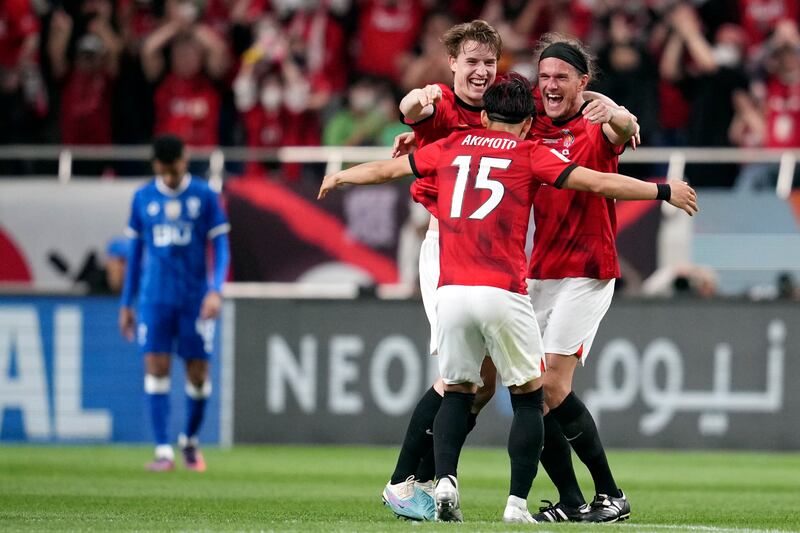 Marius Hoibraten, left, Alexander Scholz, right, and Takahiro Akimoto, centre, celebrate after Urawa Red Diamonds win the Asian Champions League final with a 2-1 aggregate victory over Al Hilal. AP