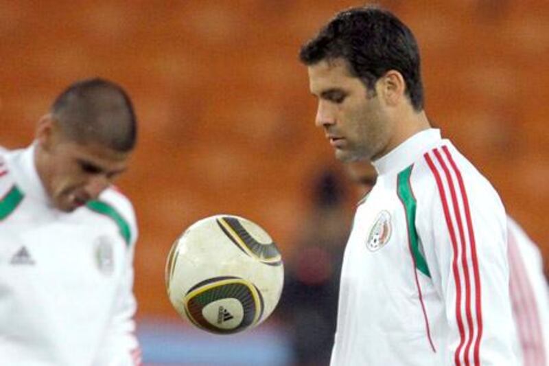 Mexico's Rafael Marquez, right, loosens up during the final training session for the soccer World Cup opening group A match between South Africa and Mexico in Soccer City in Johannesburg, South Africa, on Thursday, June 10, 2010. (AP Photo/Matt Dunham)