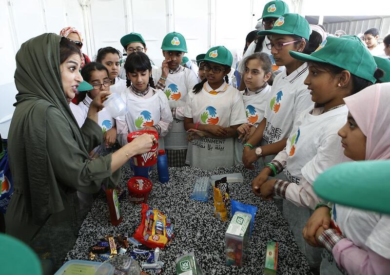 Pupils learn about plastics and littering at a beach clean-up campaign. Ravindranath K / The National