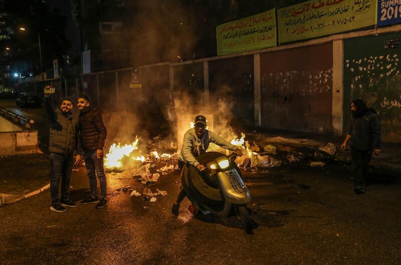 Supporters of Outgoing Prime Minister Saad Hariri close the road by burning waste during a protest against the newly appointed Lebanese Prime Minister Hassan Diab, at Al-Barbir neighborhood in Beirut.  EPA