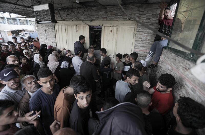 Khan Yunis camp residents line up for bread, in the southern Gaza Strip, 17 October 2023.  EPA