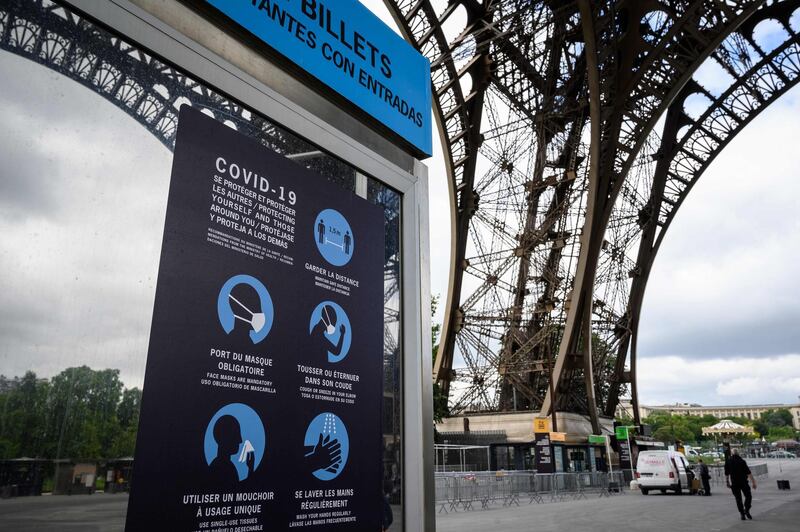 Sanitary instructions are seen in the waiting line to the Eiffel Tower ahead of the partial reopening of the monument. AFP
