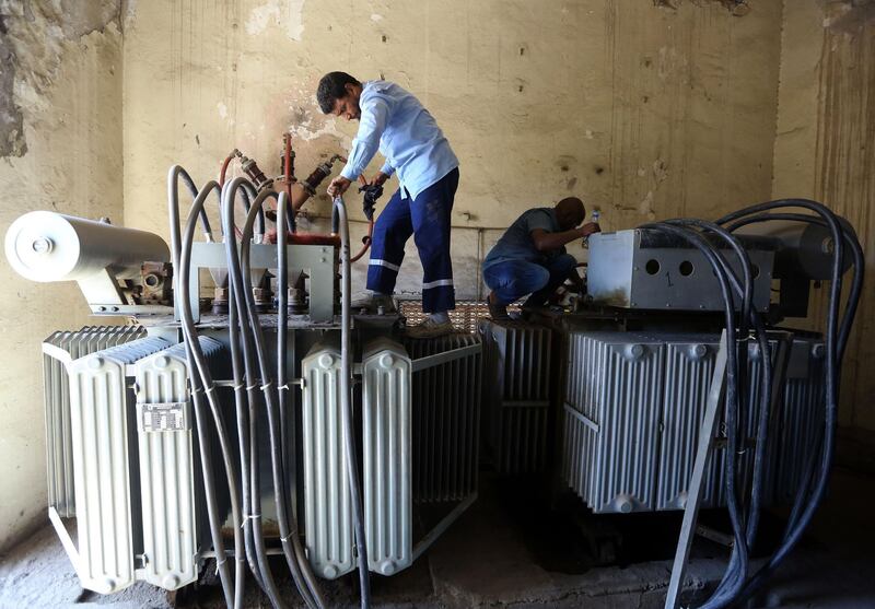 Employees of the General Electricity Company repair power converters in the Libyan capital Tripoli. AFP