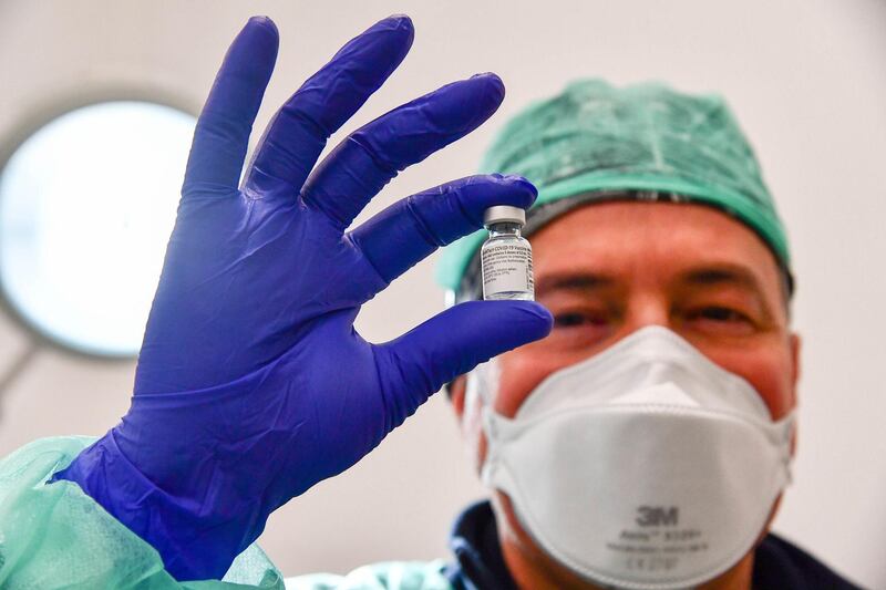 A healthcare worker prepares a syringe with a dose of the Pfizer-BioNTech vaccine at the Villa Scassi Hospital in Genoa, Italy. EPA