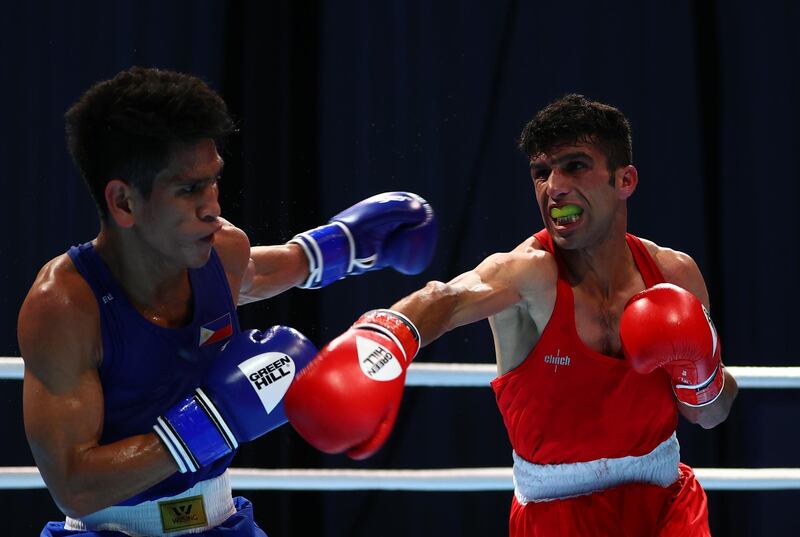 Marvin Tabamo of Philippines (blue) is caught by a right from Ramish of Afghanistan (red) in the men's flyweight 52kg category at the Asian Boxing Championships. Afghanistan recorded two victories on day one. Getty Images