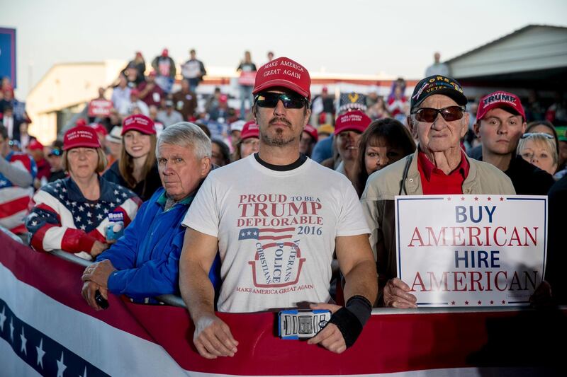 A member of the audience wears a shirt that reads "Proud to Be A Trump Deplorable" as President Donald Trump speaks at a rally at Southern Illinois Airport in Murphysboro, Ill., Saturday, Oct. 27, 2018. (AP Photo/Andrew Harnik)