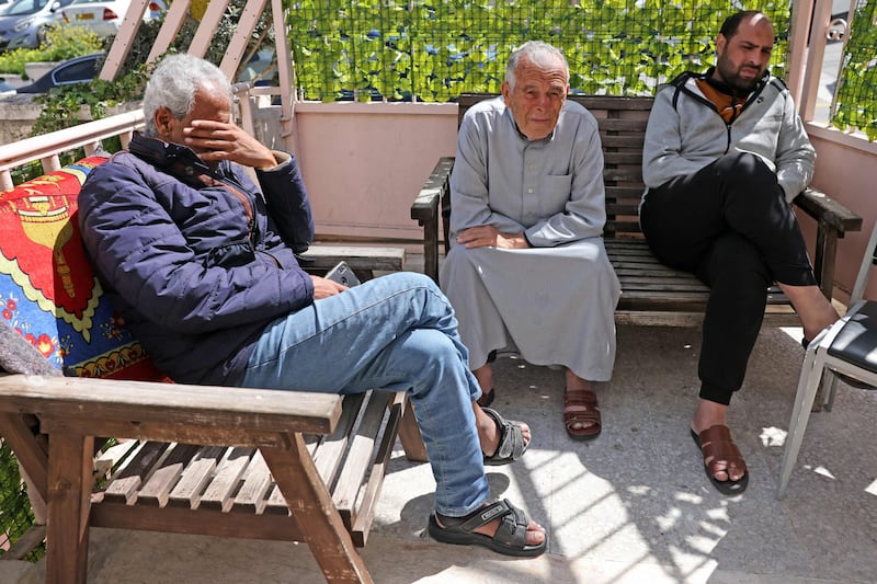 Palestinian men from Gaza sit outside a small hotel near Augusta Victoria Hospital, where they received treatment for cancer. AFP