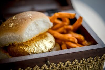The 22-karat gold O'vada pao is served in a wooden box, with liquid nitrogen, and comes with a side of sweet potato fries and mint lemonade, for Dh99. Photo: O’Pao