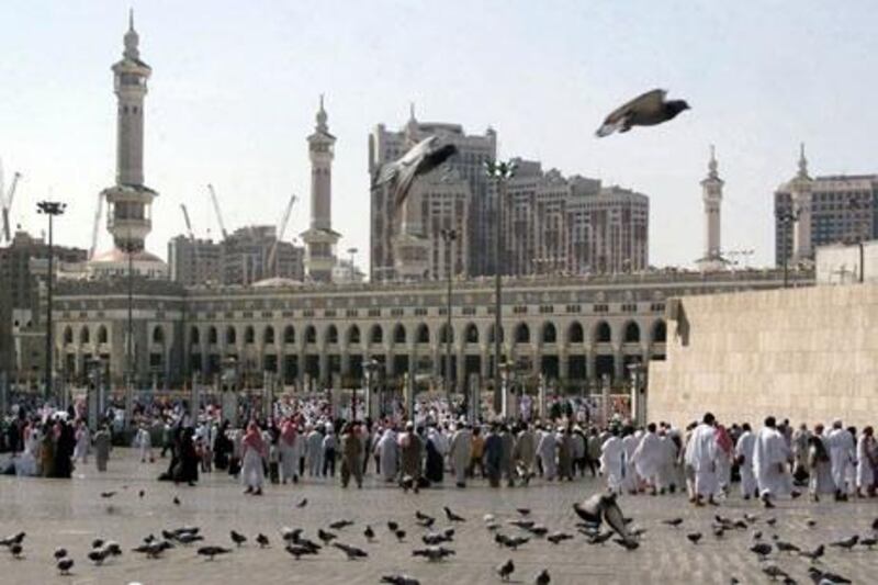 Saudi worshippers arrive at Mecca's Grand Mosque to attend the weekly Friday noon prayer 07 November 2003, one day after two suspected Islamist extremists blew themselves up as Saudi security forces closed in on them in their hunt for Islamic militants in the western Saudi city. The incident came three days after Saudi authorities said they had foiled a plot to attack pilgrims in the Muslim holy city and just hours after they reported killing a "terrorist" in Riyadh. The authorities said the alleged plot was hatched by fighters of the al-Qaeda militant network headed by Saudi-born Osama bin Laden, who planned to kill pilgrims thronging Mecca during the current Muslim fasting month of Ramadan. AFP PHOTO/Bilal QABLAN
