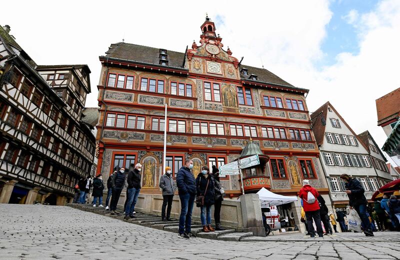 People line up for a rapid antigen test in front of the historical town hall in Tuebingen, southern Germany. AFP