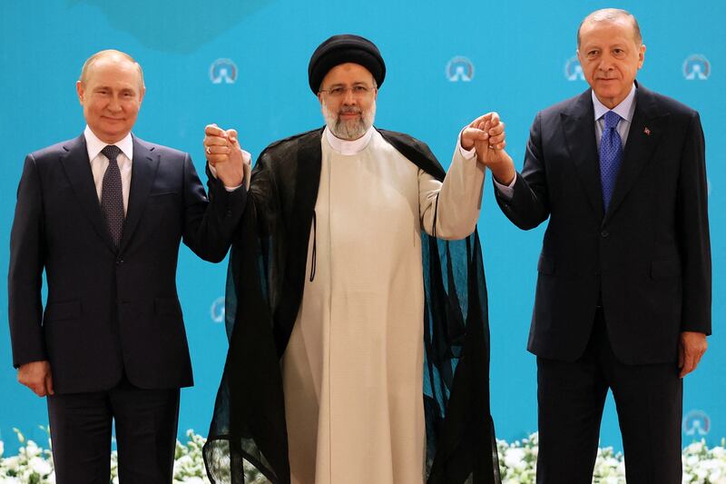 Russian President Vladimir Putin, Iranian President Ebrahim Raisi and Turkish President Recep Tayyip Erdogan pose for a photo in Tehran before holding a meeting on Syria. AFP