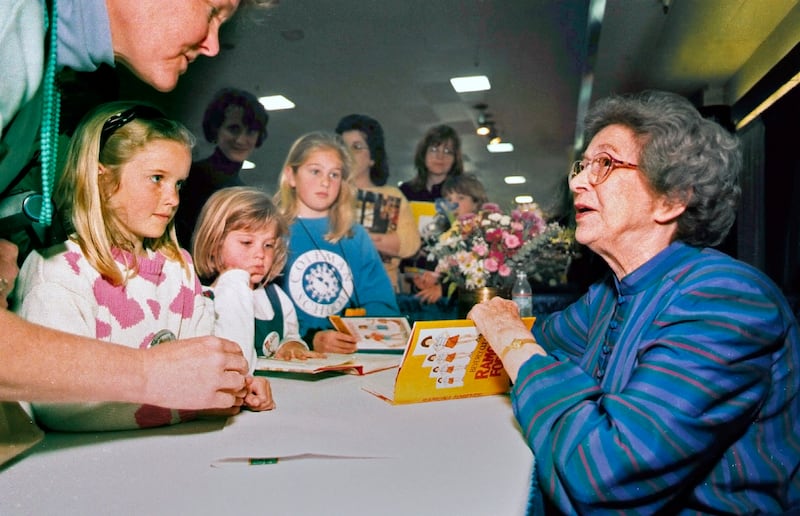FILE - In this April 19, 1998 file photo, Beverly Cleary signs books at the Monterey Bay Book Festival in Monterey, Calif. The beloved children's author, whose characters Ramona Quimby and Henry Huggins enthralled generations of youngsters, has died. She was 104. Cleary's publisher, HarperCollins, announced her death Friday, March 26, 2021. In a statement, the company said Cleary died in Carmel, California, her home since the 1960s, on Thursday. No cause of death was given. (Vern Fisher/The Monterey County Herald via AP, File)