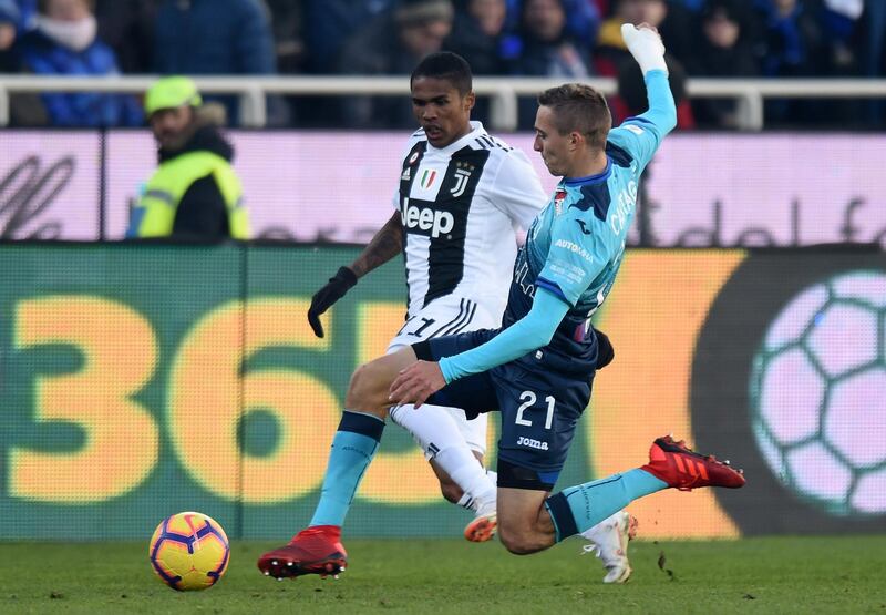 Douglas Costa (L) of Juventus is challenged by Timothy Castagne of Atalanta during the Serie A match between Atalanta BC and Juventus at Stadio Atleti Azzurri d'Italia in Bergamo, Italy.  Getty Images