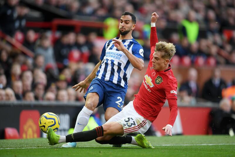 Brandon Williams of Manchester United challenges Martin Montoya of Brighton in Manchester on Sunday. Getty Images