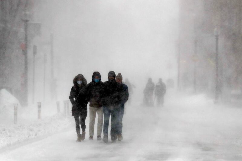 People walk on State Street, in Boston.  AP