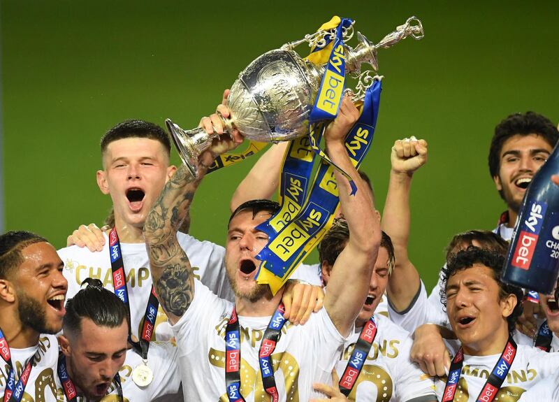 Liam Cooper llifts the trophy in celebration with teammates. Getty