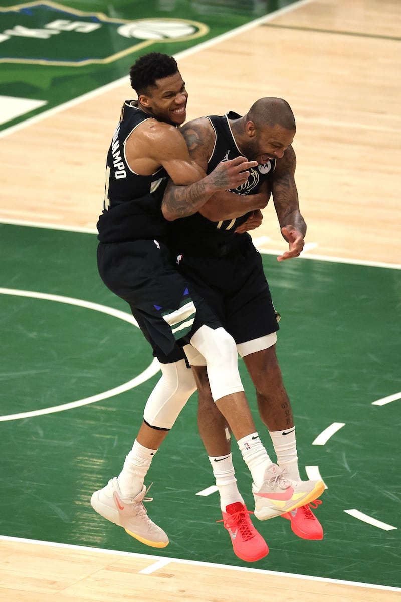 Giannis Antetokounmpo and PJ Tucker of the Milwaukee Bucks celebrate after defeating the Phoenix Suns in Game Six.