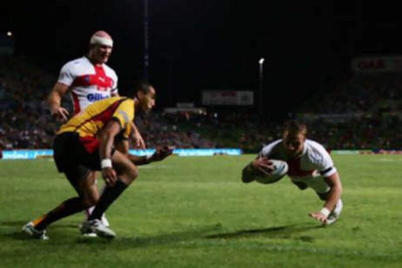 England's Lee Smith dives in the corner to score a try in the opening match of the 2008 Rugby League World Cup against Papua New Guinea.