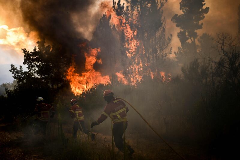 Firefighters combat large flames in Orjais. AFP