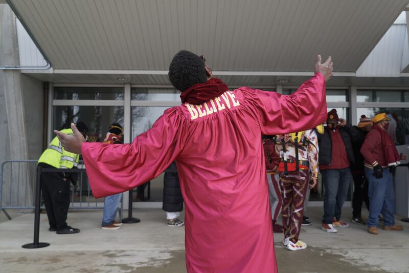 A man wearing a minister's robe entertained fans as they waited in line for the gift shop to open. Willy Lowry / The National.