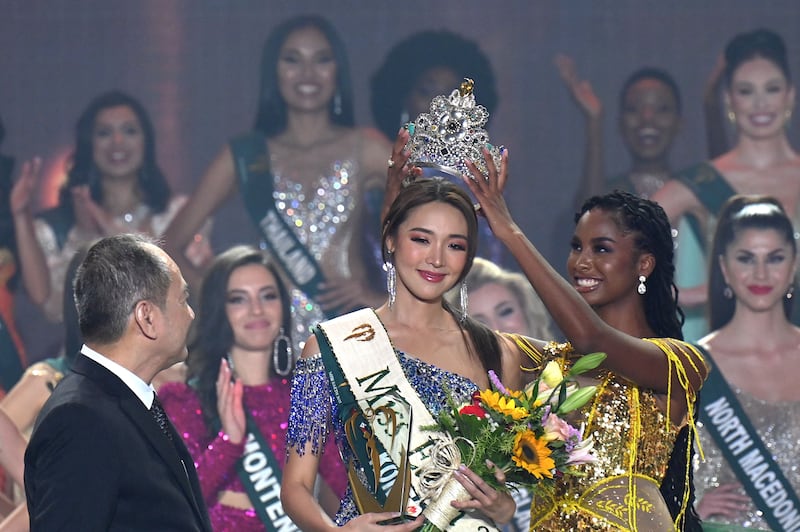 Miss Earth 2021, Destiny Wagner, passes the crown to Miss Earth 2022 Mina Sue Choi, from South Korea, in Manila. AFP
