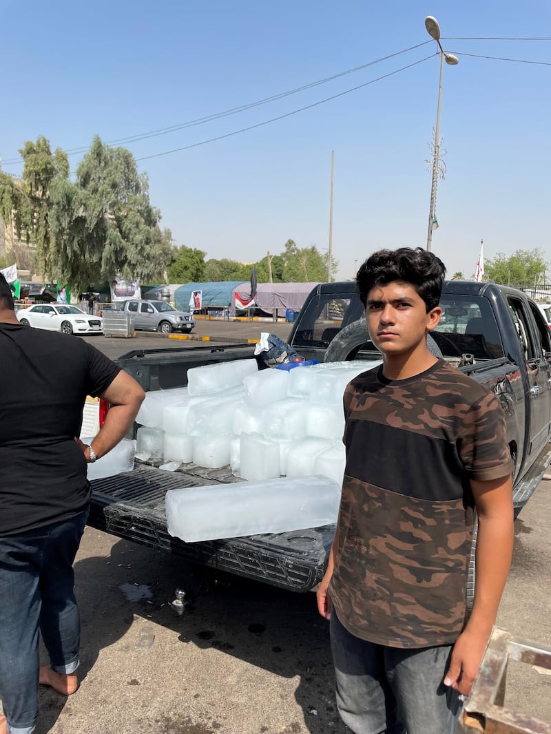 Volunteers unload ice blocks from a pick-up truck for the protesters. 