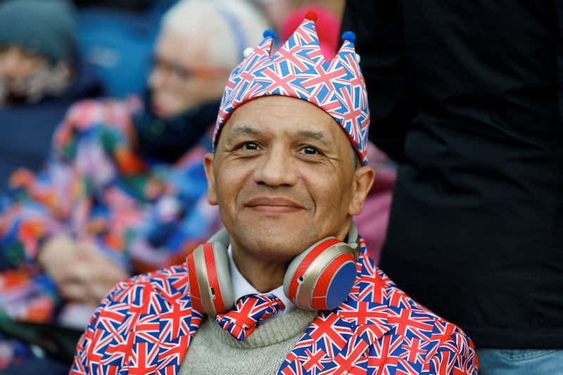 A reveller wears a suit of Union flags as he waits to watch King Charles's coronation procession in The Mall in London. Reuters