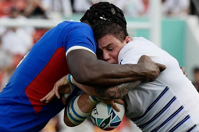 TOPSHOT - Namibia's lock Tjiuee Uanivi (L) tackles Italy's hooker Oliviero Fabiani during the Japan 2019 Rugby World Cup Pool B match between Italy and Namibia at the Hanazono Rugby Stadium in Higashiosaka on September 22, 2019. / AFP / Filippo MONTEFORTE
