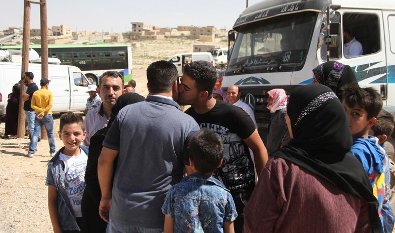 epa06906675 Displaced Syrians hug each others upon their return from Lebanon, through al-Zamrani corridor to their homes in al-Qalamoun area in Damascus countryside, Syria, 23 July 2018. According to media reports, Lebanon hosts 1,011,366 Syrian refugees registered with UNHCR, Including 80 thousand refugees living in seven camps in the city of Arsal. Some 900 displaced Syrians would return. this is the third batch of displaced Syrians, who have recently returned to their homeland.  EPA/STR