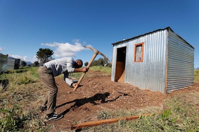epa06966365 (FILE) - A South African man builds an illegally erected shack during a land invasion on the property of Louiesenhof Wine farm in the heart of the major wine producing region of Stellenbosch, South Africa, 08 August 2018 (reissued 23 August 2018). According to reports, South African Minister of International Relations and Cooperation, Lindiwe Sisulu wants to communicate with US Secretary of State Pompeo over 'regrettable' remarks US President Donald J. Trump made on South Africa's land reform plans. A major debate around land expropriation without compensation is being waged in the country at present. Parliamentarians are currently debating to amend the constitution to allow for land expropriation.  EPA/NIC BOTHMA