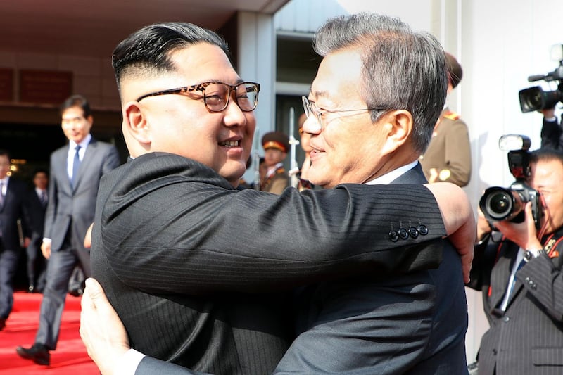 TOPSHOT - This picture taken on May 26, 2018 and released by the Blue House via Dong-A Ilbo shows South Korea's President Moon Jae-in (R) hugging North Korea's leader Kim Jong Un after their second summit at the north side of the truce village of Panmunjom in the Demilitarized Zone (DMZ). South Korea said President Moon Jae-in met with North Korea's leader Kim Jong Un on May 26 inside the Demilitarised Zone dividing the two nations, a day after US President Donald Trump threatened to abandon a summit with Pyongyang. - South Korea OUT
 / AFP / Dong-A Ilbo / Handout
