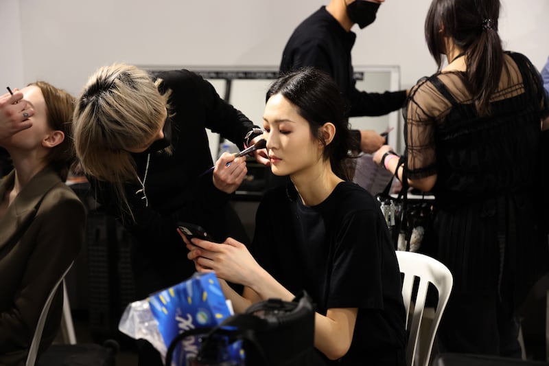 A model gets her make-up done for the Elie Saab womenswear autumn/winter 2022-2023 show.