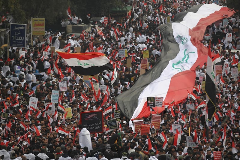 Thousands of Iraqis, waving national flags, take to the streets in central Baghdad. AFP