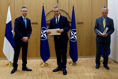 Left to right, Finland's ambassador to Nato, Klaus Korhonen, Nato Secretary General Jens Stoltenberg and Sweden's ambassador to the alliance Axel Wernhoff in Brussels. Reuters