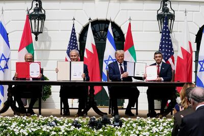 FILE - In this Sept. 15, 2020, file photo, from left; Bahrain Foreign Minister Khalid bin Ahmed Al Khalifa, Israeli Prime Minister Benjamin Netanyahu, U.S. President Donald Trump, and United Arab Emirates Foreign Minister Abdullah bin Zayed al-Nahyan, sit during the Abraham Accords signing ceremony on the South Lawn of the White House, in Washington. As Israel heads to the polls next week for the fourth time in two years, Prime Minister Benjamin Netanyahu has sought to capitalize on his new partnership with the United Arab Emirates in his desperate campaign to stay in power. (AP Photo/Alex Brandon, File)