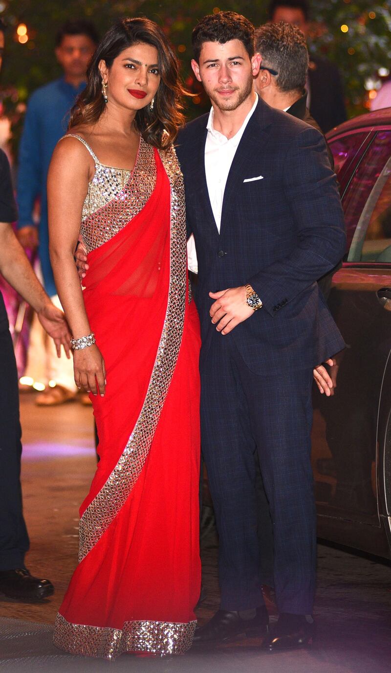 Indian Bollywood actress Priyanka Chopra (L) accompanied by Nick Jonas arrive for the pre-engagement party on Thursday night (the couple are now en route to Brazil). AFP
