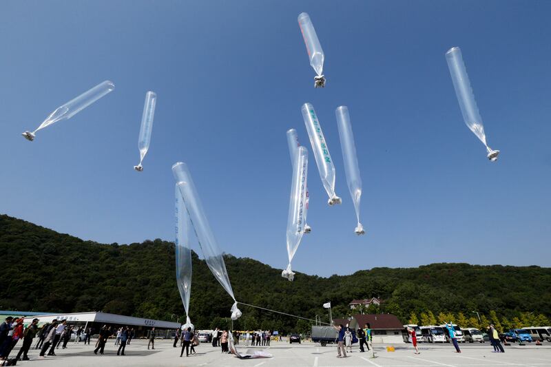 North Korean defectors release balloons carrying leaflets condemning the country's leader, Kim Jong-un, in Paju, South Korea. AP