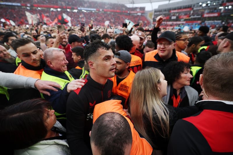 Granit Xhaka of Bayer Leverkusen celebrates with fans. Getty Images