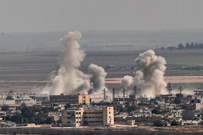 Smoke rises from the Syrian town of Ras al-Ain, in a picture taken from the Turkish side of the border in Ceylanpinar on October 11, 2019, on the third day of Turkey's military operation against Kurdish forces. Turkey will not stop its operation against Kurdish militants in northern Syria, President Recep Tayyip Erdogan said Friday, dismissing what he called "threats" from other countries.  / AFP / Ozan KOSE
