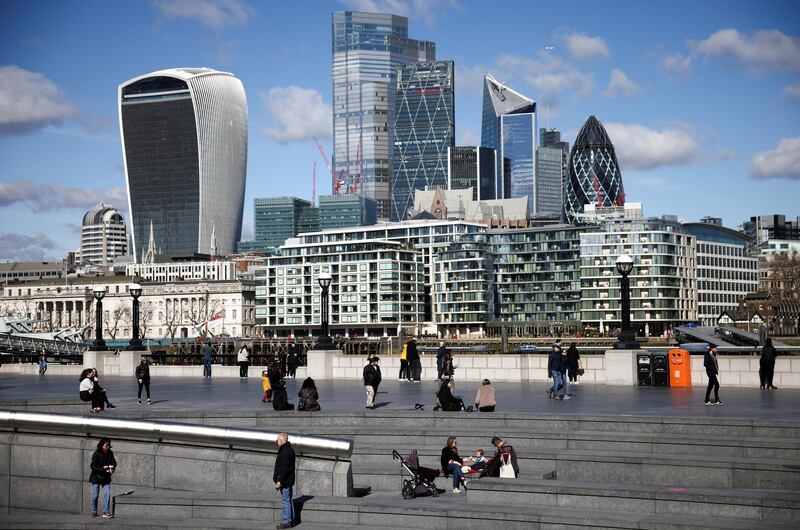 FILE PHOTO: The City of London financial district can be seen as people walk along the south side of the River Thames, amid the coronavirus disease (COVID-19) outbreak in London, Britain, March 19, 2021. REUTERS/Henry Nicholls//File Photo