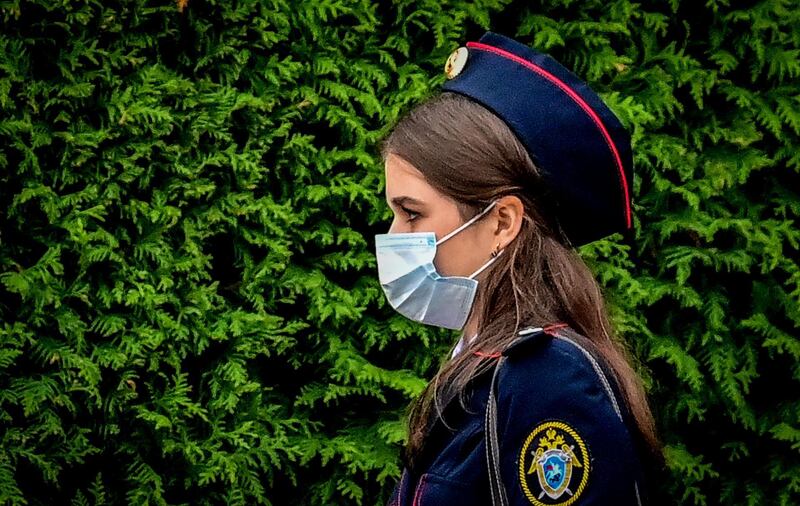 A Russian police cadet wears a face mask while walking through central Moscow. AFP