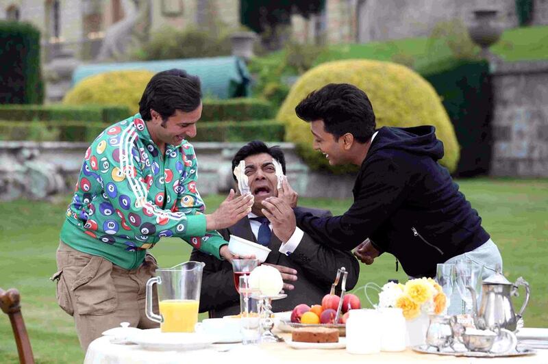 Saif Ali Khan, left, and Riteish Deshmukh, right, give Ram Kapoor a butter facial in a scene from Humshakals. Courtesy Puja Films