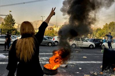 Iranians protests the death of 22-year-old Mahsa Amini after she was detained by the morality police in Tehran on October 1 in a picture obtained by the AP outside Iran. AP