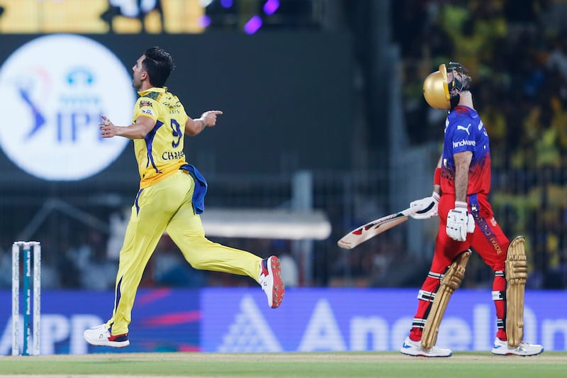 Chennai Super Kings' Deepak Chahar, left, celebrates the wicket of Royal Challengers Bengaluru's Glenn Maxwell, who was caught by wicketkeeper MS Dhoni without scoring. AP 